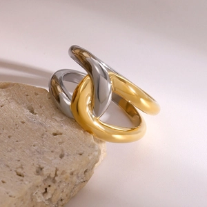 Minimalist interlocking cross ring in gold and silver finish with polished metal texture