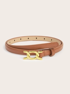 Detail of a thin brown PU leather belt with a golden interlocking buckle and adjustment holes