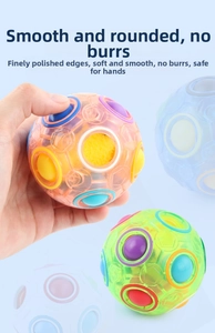 Macro detail of hand holding a 12-hole rainbow magic ball puzzle toy for logic training