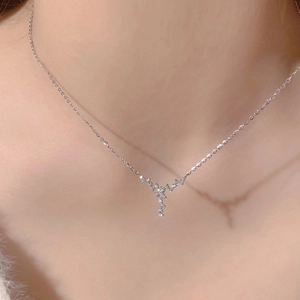 Silver V-shaped necklace with sparkling zircons and minimalist star design on model