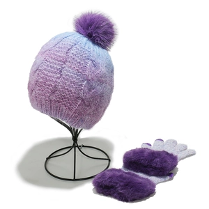 Detail of purple tie-dye knit hat with pompom and gloves featuring faux fur cuffs