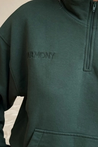 Detail of forest green half-zip sweatshirt with high-quality letter embroidery