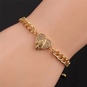 Golden Cuban chain heart bracelet with religious figure and pavé cubic zirconia