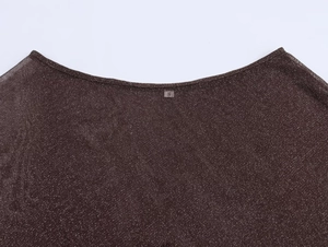 Detail shot of brown metallic yarn fabric texture and size S label on neckline