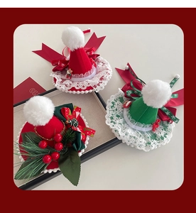 Macro detail of handmade Christmas mini hat hair clips with lace bows and fur balls