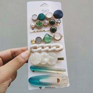 Detailed set of 8 candy-colored hair clips with pearls and resin charms on white card