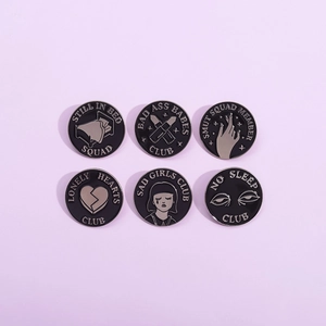 Set of six black and silver enamel pins featuring creative subculture club illustrations