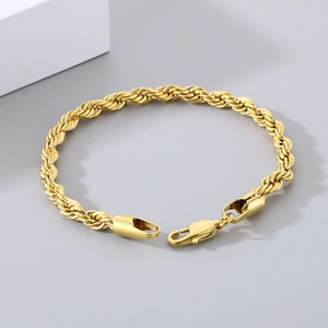 Detailed macro view of a golden twist rope bracelet with a secure lobster clasp