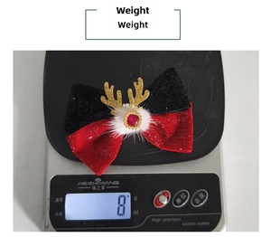 Detailed view of lightweight Christmas reindeer antler hair clip weighing 8g on a scale