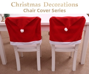 Detail view of 2pcs red Santa hat chair covers with white plush balls for festive dining decor