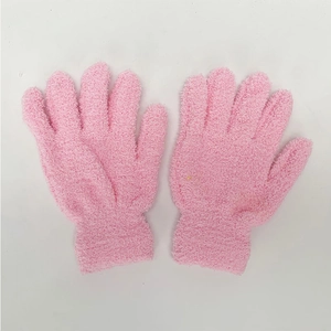 Close-up of soft pink winter plush gloves featuring elastic cuffs and thick thermal texture