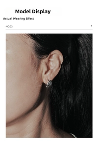 Close-up of a silver punk dragon wing ear cuff earring worn by a model in profile