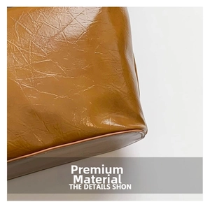 Detailed view of caramel brown oil wax PU leather with natural wrinkled texture and edges