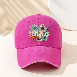 Close-up of pink washed cotton baseball cap featuring floral MAMA embroidery detail