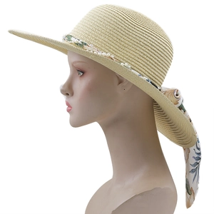 Bohemian woven straw sun hat with elegant pearl trim and floral ribbon detail for women