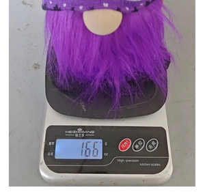 Weight display of Halloween purple beard gnome plush on digital scale 166g