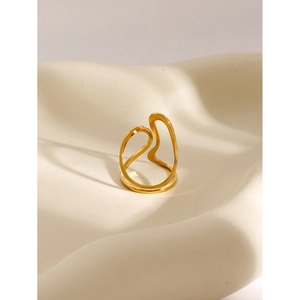 Macro shot of 18k gold irregular fluid open ring on a textured cream minimalist surface