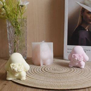 Detail of bunny candle mold with floral bouquet rabbit gypsum crafts on woven mat