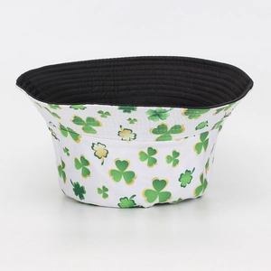 Detailed view of the green shamrock print on a white outdoor bucket hat