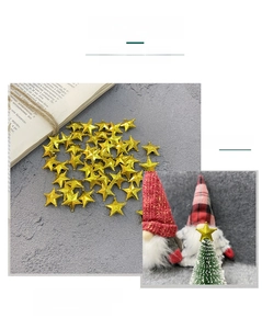 Macro shot of 2cm golden plastic star ornaments for Christmas cake and tree decorations