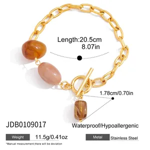 Macro detail of OT buckle stainless steel bracelet with amber resin charms and size info