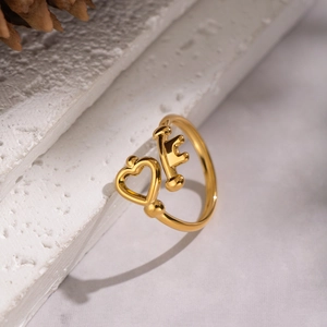 Detailed close-up of 18K gold stainless steel open ring with heart and key design on stone