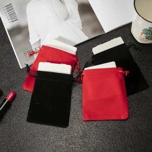 Mini PU leather makeup mirrors with elegant red and black velvet pouches on a desk