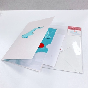 Detail of 3D greeting card with blue whale illustration and envelope in clear packaging