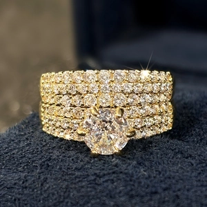 Macro shot of gold wedding ring set with four rows of pave diamonds and large center stone