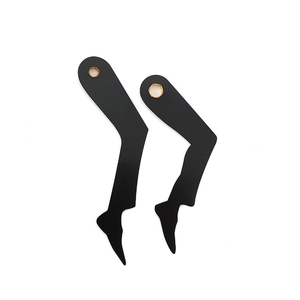 Modern black leg-shaped clock hands set with golden hexagonal holes on white background