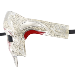 Detail of white crackle Venetian half mask with red and silver embossed patterns
