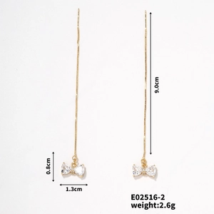 Detailed view of long gold tassel earrings with zircon bow and 9.0cm length measurement