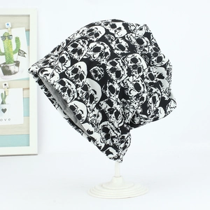 Detail view of double-layer knit beanie with skull print and grey inner lining