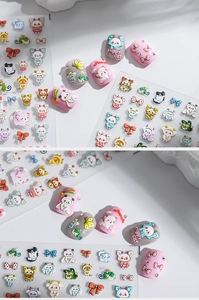 Detailed 3D relief nail stickers featuring cute cartoon cats and bows on pink manicured nails