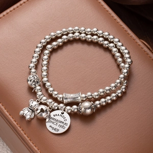 Double-layer silver bead bracelet with lucky cat and teddy bear charms on leather