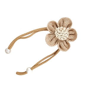 Handmade burlap flower curtain tieback with white pearls on a minimalist background