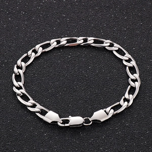 Close-up of silver Figaro link chain necklace with lobster clasp on black background