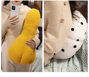 Detail of plush pumpkin pillows in yellow and polka dot fabric with soft teddy fleece texture