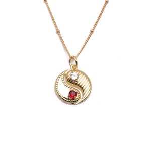 Gold plated Bagua pendant necklace with red and clear zircon crystals on white background