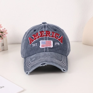 Distressed denim baseball cap with American flag embroidery and AMERICA 1776 lettering