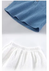 Detail of blue cotton gauze top hem and white elastic shorts waistband for kids