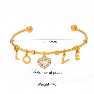 Gold stainless steel open bangle with LOVE charms and white mother of pearl heart pendant