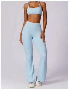 Detail of light blue sports bra and flared leggings set with elastic performance fabric