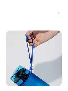 Detail of 32oz sports bottle featuring a durable fabric carrying strap and secure locking lid