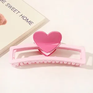 Detailed view of pink heart hair claw clip with smooth finish and rectangular hollow base