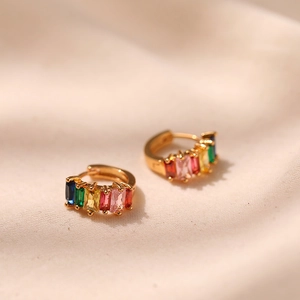 Close-up of gold hoop earrings with multi-color rectangular zircon rainbow stones