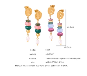 Detail view of handmade drop earrings with natural agate beads and freshwater pearls