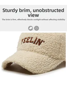 Close-up of soft beige teddy fleece baseball cap with brown FEELIN' embroidery detail