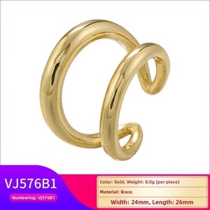 Detail of golden brass geometric double ring with dimensions 24mm by 26mm