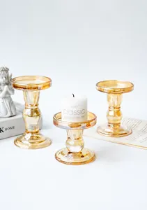 Set of three amber glass candle holders featuring classic Roman column design and texture